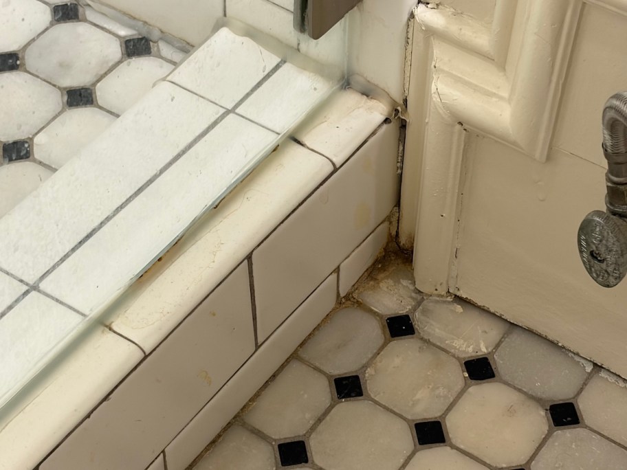 close up of dirty grout in shower bathroom