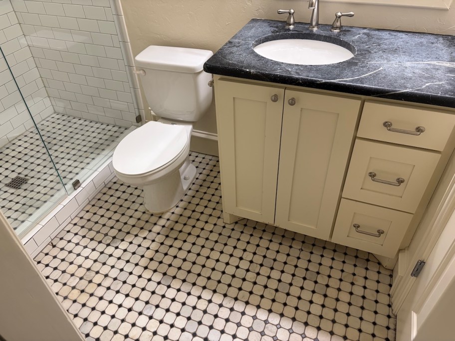 bathroom with single vanity and toilet