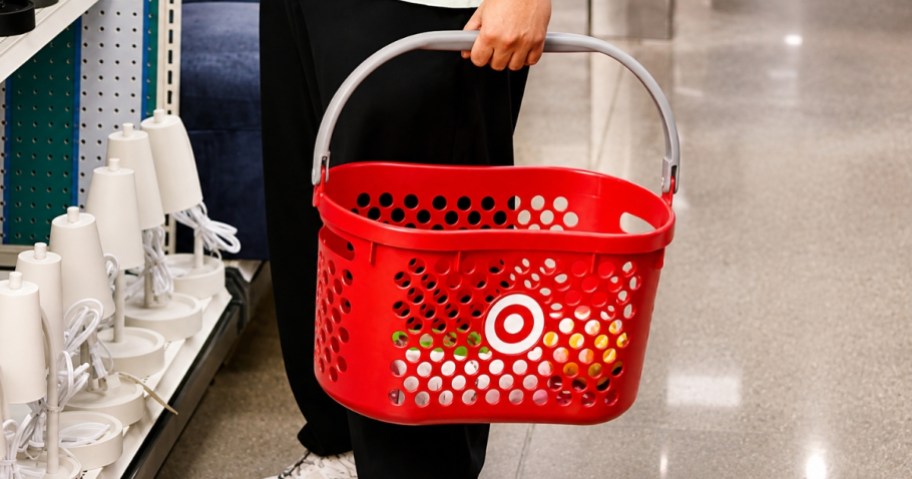 man in a Target store aisle holding a shopping basket
