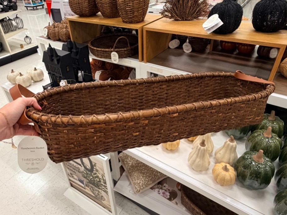 holding a long brown basket