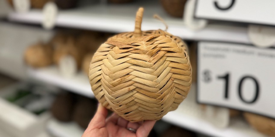 hand holding woven pumpkin 
