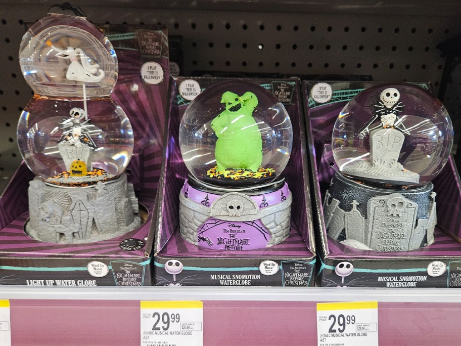 three halloween water globes on shelf 
