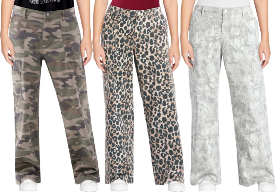 Three pairs of women's cargo pants worn by models, featuring green camouflage print on the left, leopard print in the middle, and a light grey abstract print on the right.