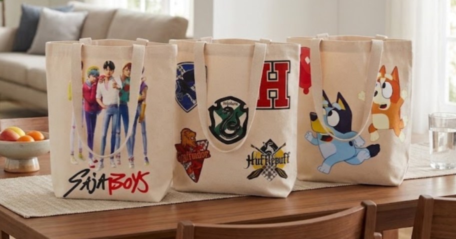 three character tote bags on a kitchen table