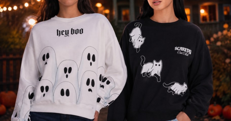 two women wearing Halloween graphic sweatshirts