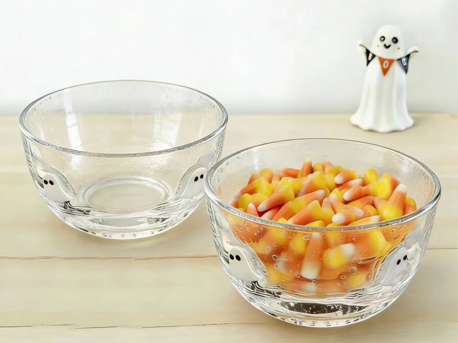 two glass bowls, one filled with candy corn