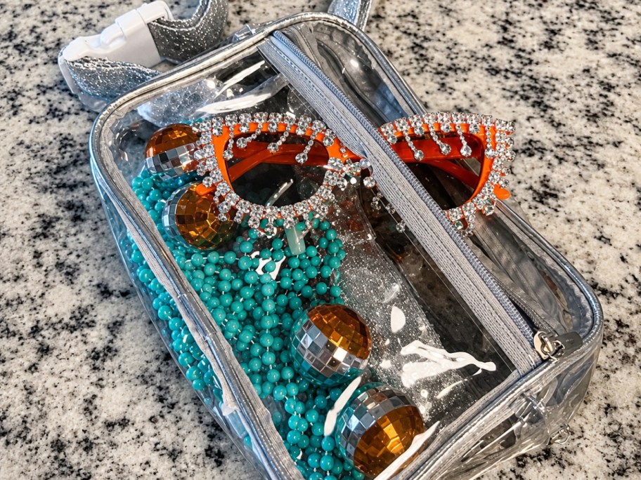 clear fanny pack on countertop filled with beads and glasses
