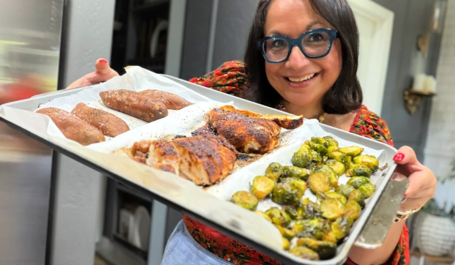 woman holding a sheet pan meal 