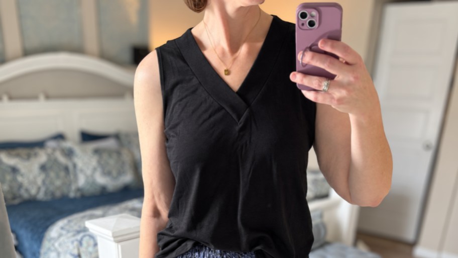 woman in a tanktop taking a selfie