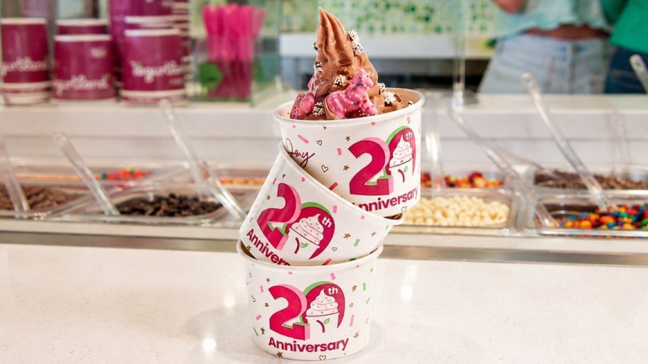 yogurtland 20th anniversary cups on a yogurtland counter. 