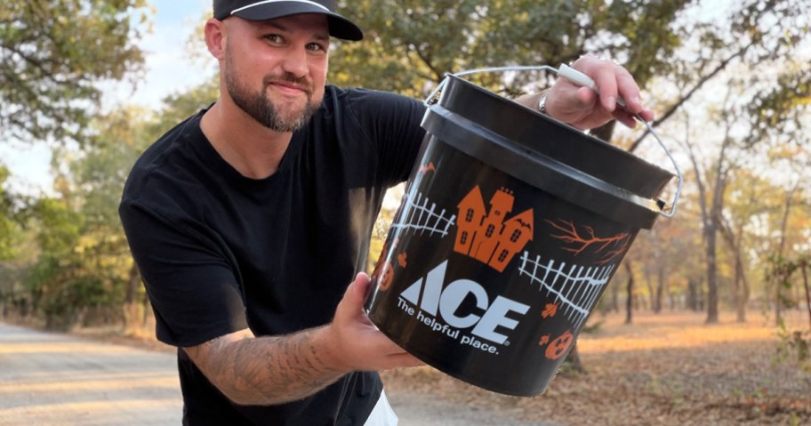 Ace Hardware Halloween Bucket being held by smiling man