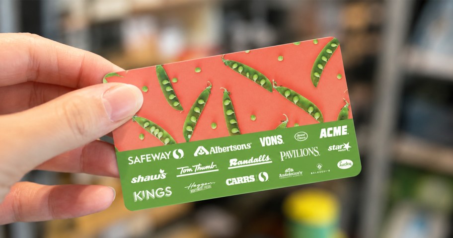 hand holding up an Albertson's Companies Gift Card in store