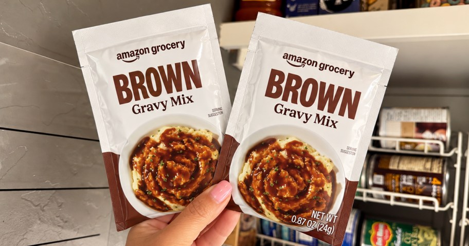 hand holding up two packets of Amazon Grocery Gravy Mix