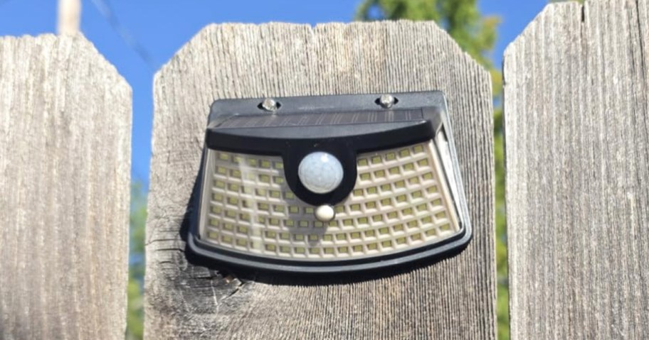 solar light hanging on a fence