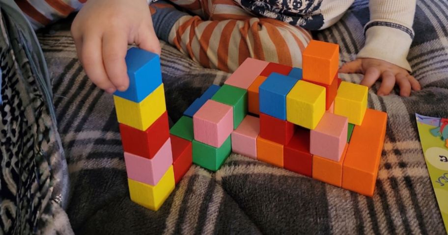 kid playing with Apluses 42-Piece Magnetic Blocks