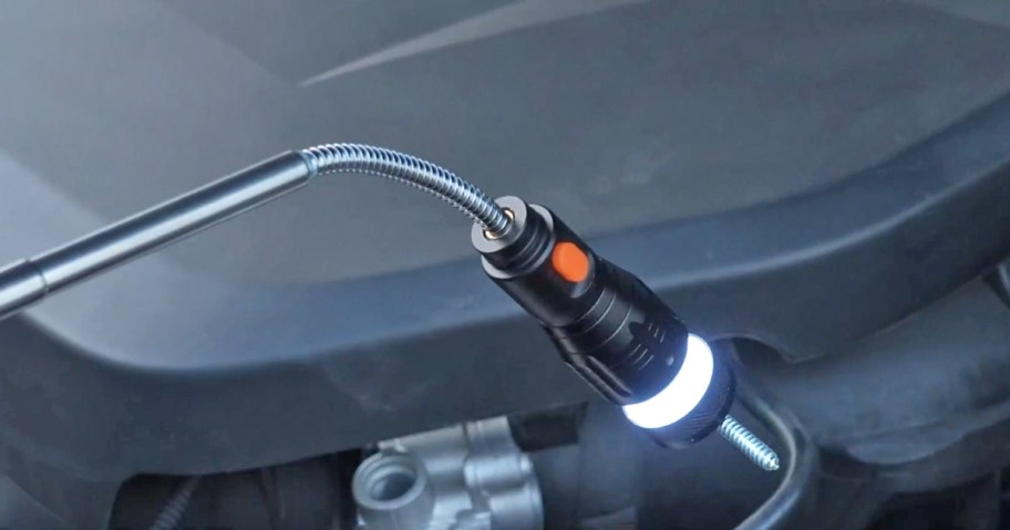 magnetic pickup tool with light picking up a screw