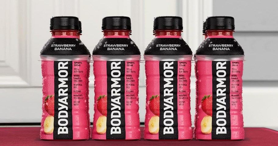 pink bottles of BODYARMOR Sports Drinks on front door step