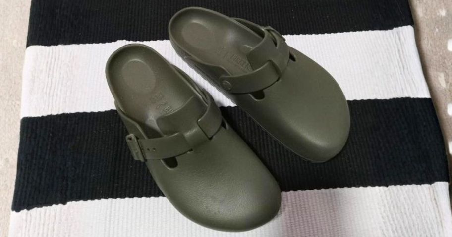 green Birkenstock Adjustable Recovery Clogs on blanket