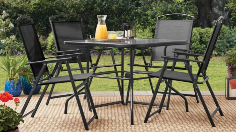Bistro set on a rug with juice jug on top