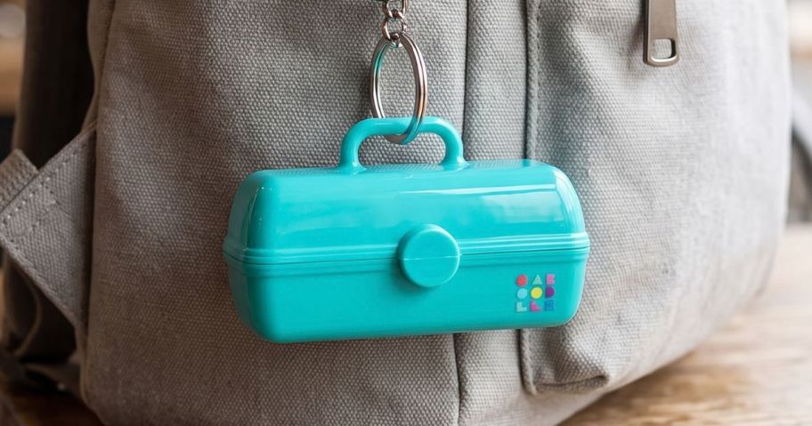Caboodles Mini On-The-Go Girl Keychain hanging on bag