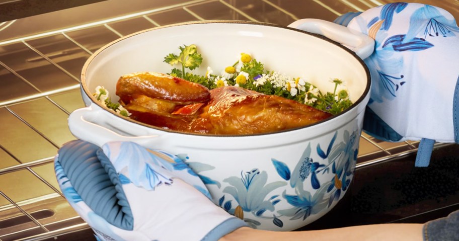 taking floral print dutch oven out of oven