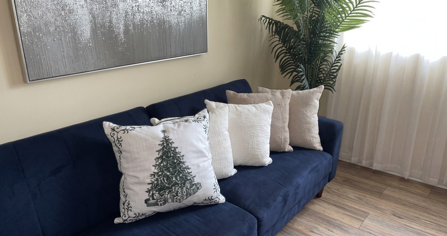 My Texas House Vintage Christmas Tree Decorative Pillow displayed on a navy blue sofa.