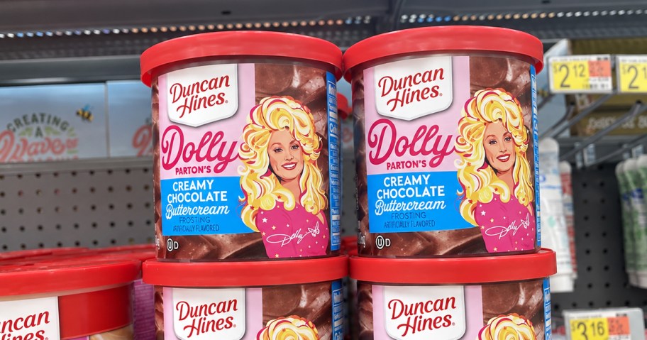 cans of Duncan Hines Dolly Parton frostings on walmart shelf