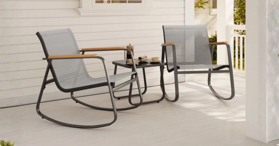 Ebern Designs 3-Piece Outdoor Rocking Patio Set w/ Solid Wood Armrests & Coffee Table on porch