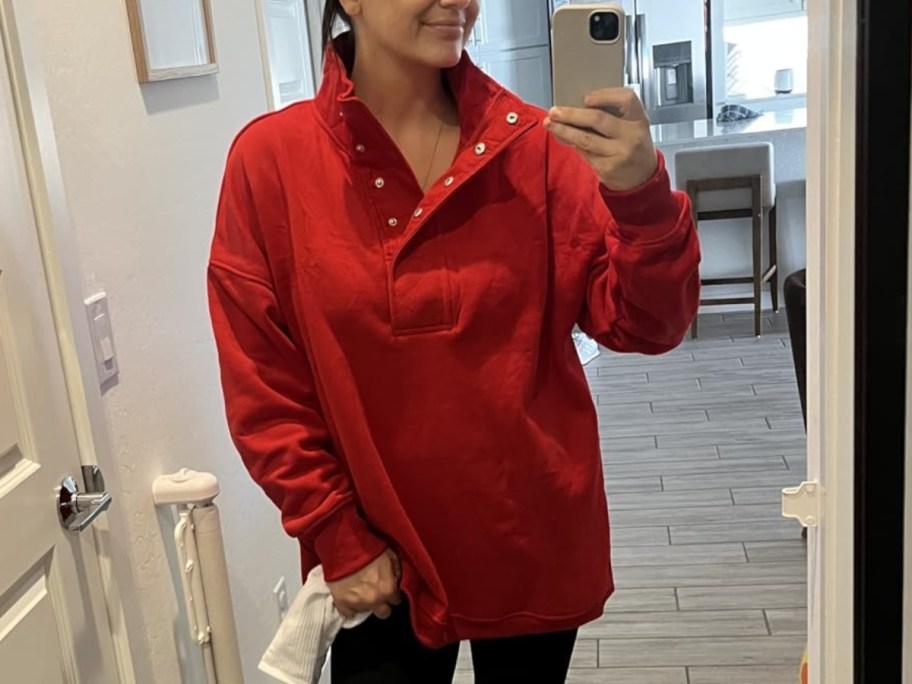 woman taking selfie in red henley sweatshirt