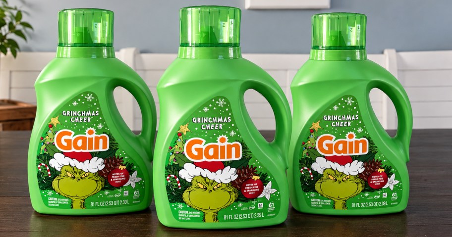3 green bottles of Gain Grinchmas Cheer Laundry Detergent on table