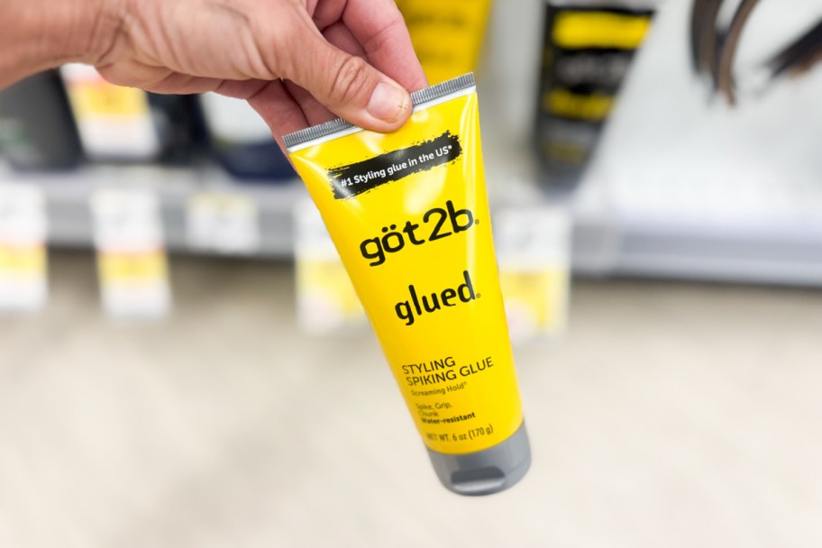hand holding yellow gel tube in store