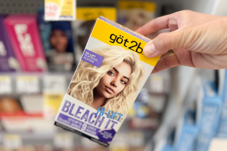 hand grabbing hair bleach box in store
