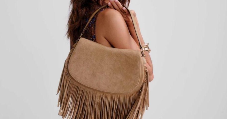 woman holding a Scenario Fringe handbag