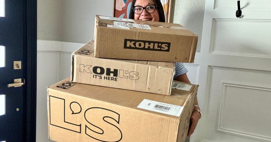 Woman holding a huge stack of Kohl's Boxes