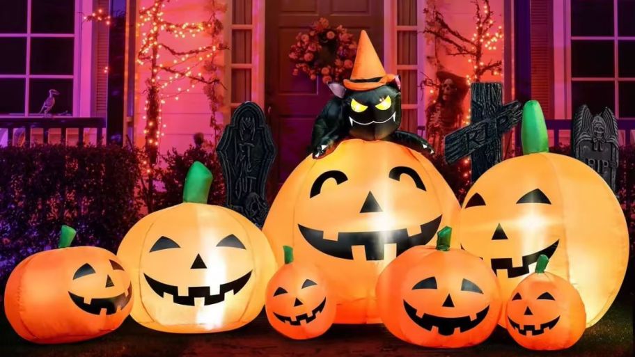 Large pumpkin set with cat on top set up outside