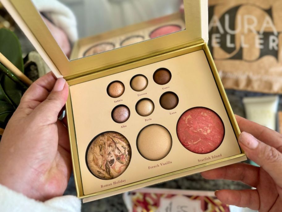 Hand holding a Laura Geller Tuscan Dreams Palette