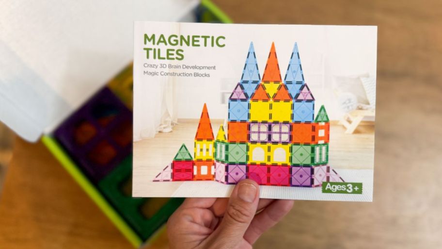 hand holding Magnetic tiles with the box underneath