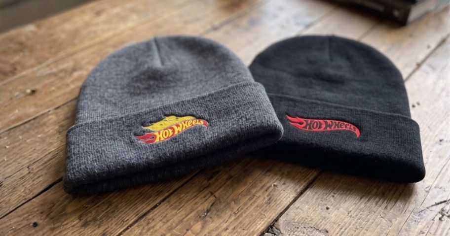 two Men's Licensed hot wheels Beanie-Style Hats on table
