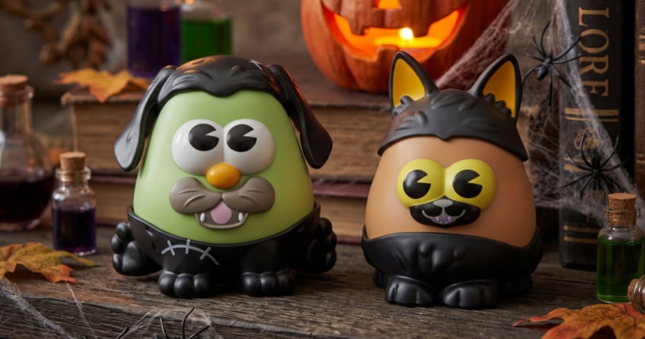 2 mr potato head halloween toys in a halloween background
