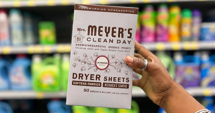 hand holding up a box of Mrs. Meyer's Dryer Sheets in store aisle