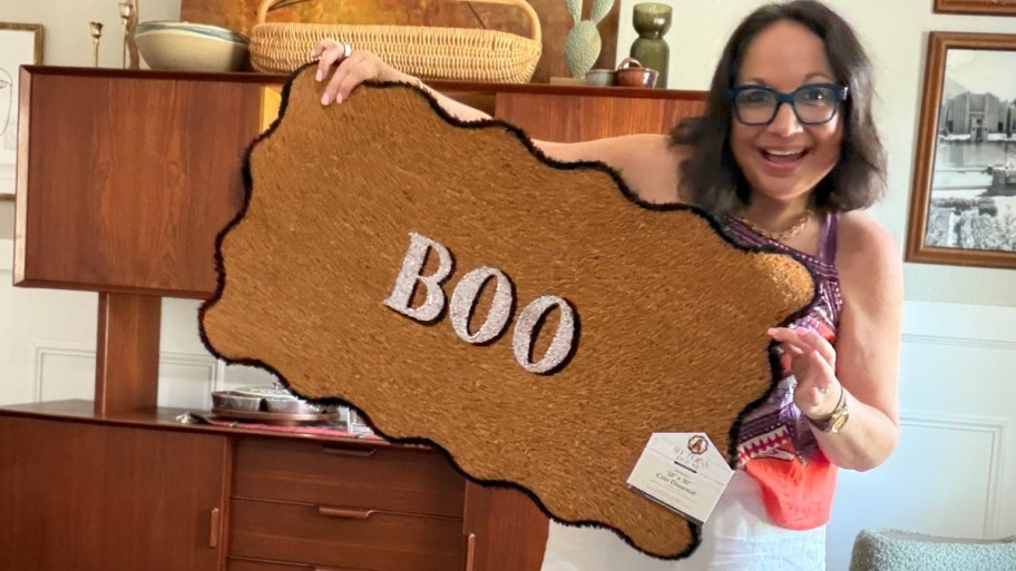 woman holding a doormat