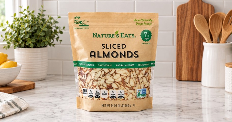 bag of nature's eats sliced almonds sitting on kitchen counter with utensils, a plant, and bowl of lemons in background