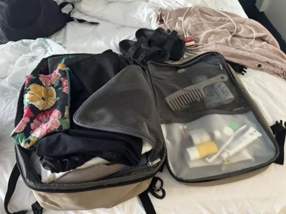 Open Story 35L Travel Backpack open on bed