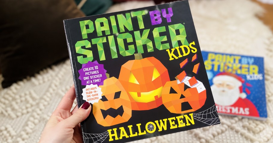 hand holding a paint by sticker halloween book