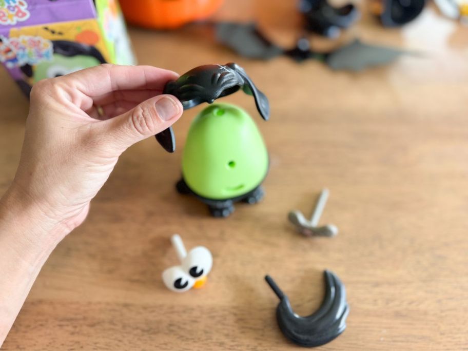 person putting the Potato Head Spooky Spuds Frankenspud Pup together on table