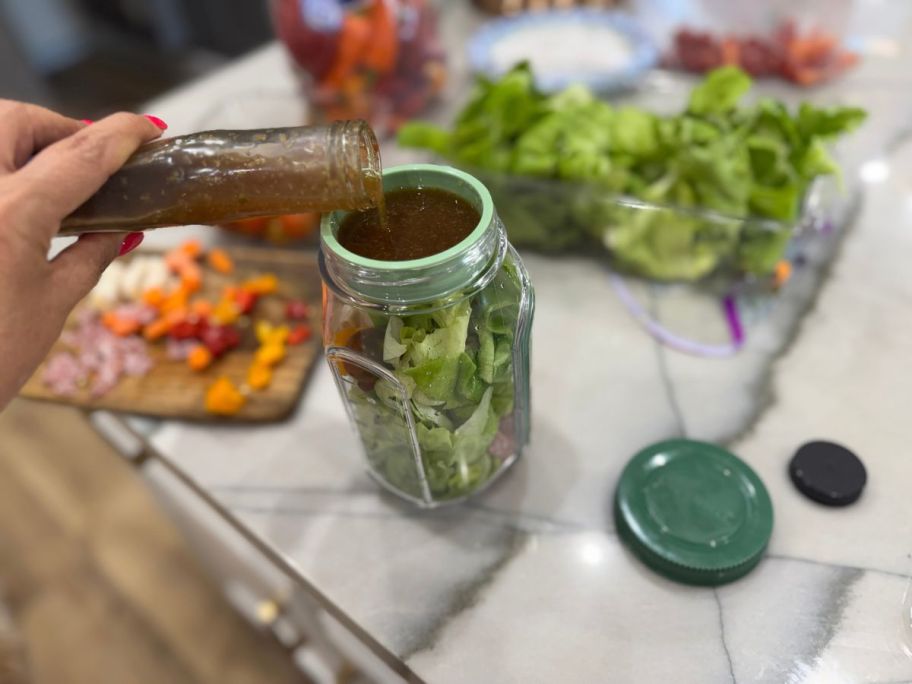 lina putting dressing into Prepara Portable Salad Pod
