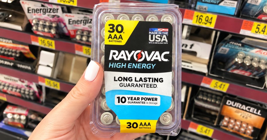 hand holding up a pack of Rayovac AAA Batteries
