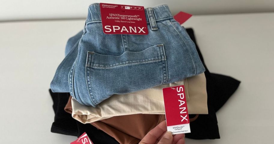 A stack of Spanx clothing new with tags