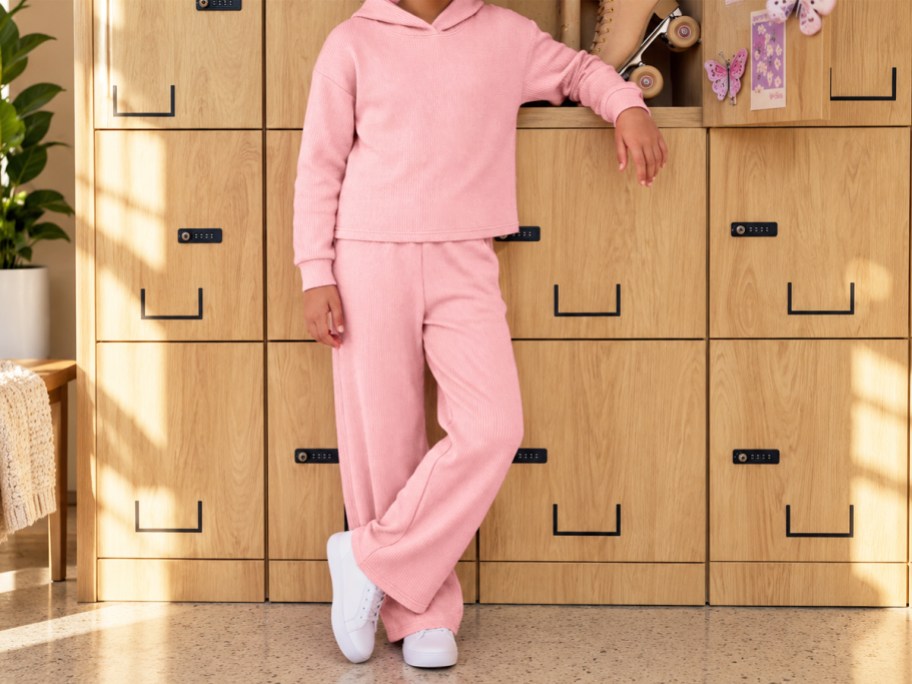 girl wearing a matching pink sweatshirt and sweatpants set