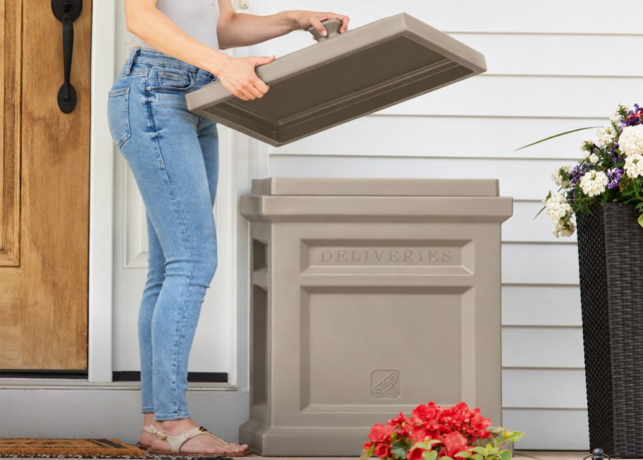 a woman lifting the lid off a parcel delivery box